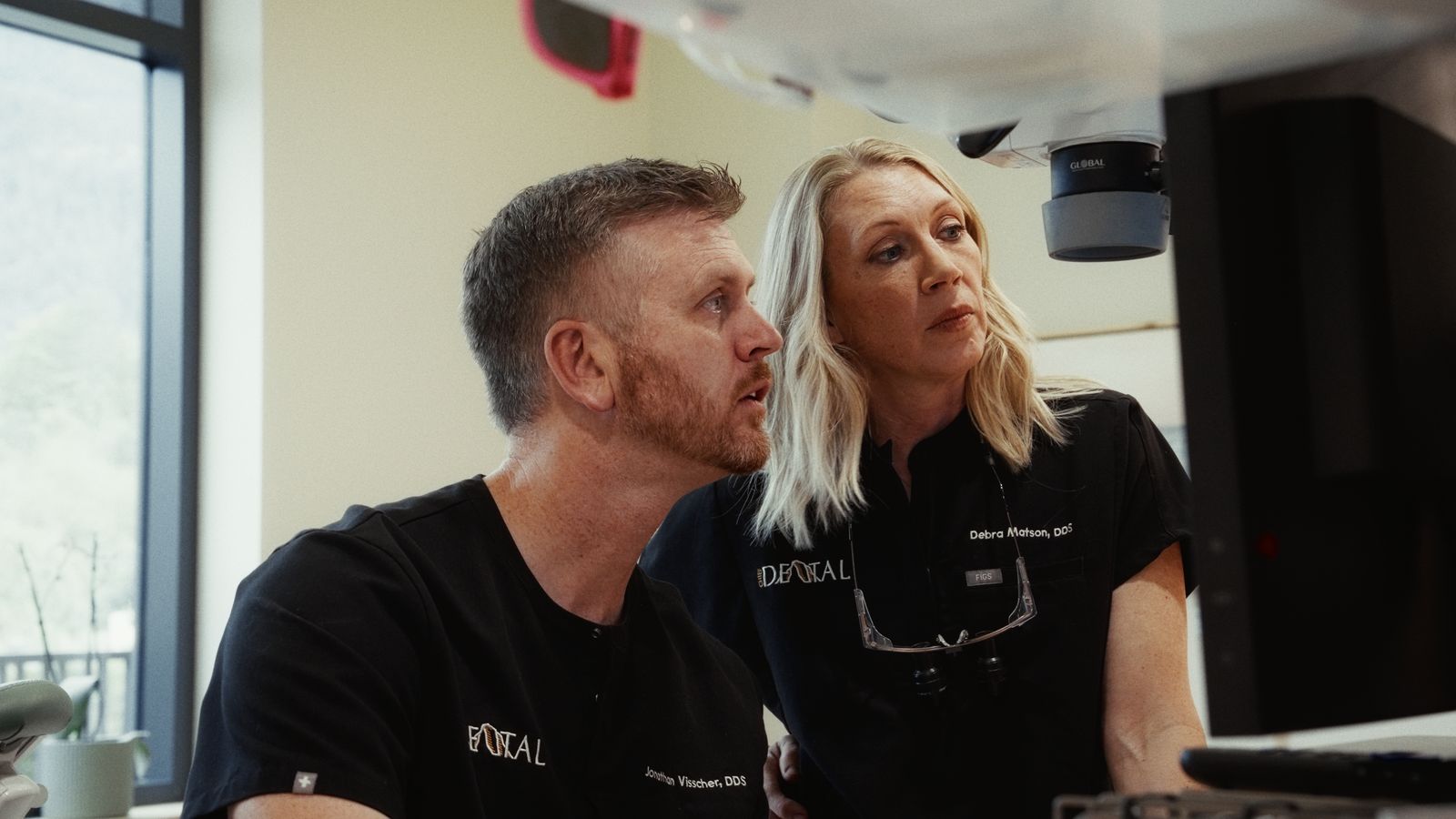 Dr. Jonathan Visscher and Dr. Debra Matson looking at a patient's records
